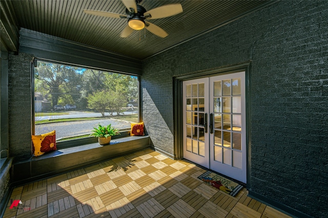 sunroom featuring french doors, ceiling fan, and a healthy amount of sunlight