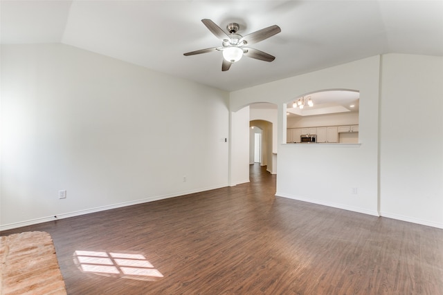 unfurnished living room featuring lofted ceiling, dark hardwood / wood-style floors, and ceiling fan