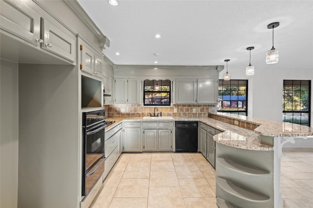 kitchen featuring tasteful backsplash, a warming drawer, black appliances, a sink, and a peninsula