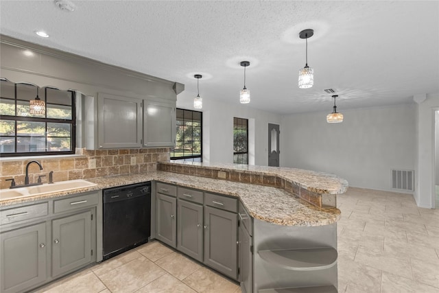 kitchen featuring dishwasher, a sink, gray cabinetry, visible vents, and a peninsula
