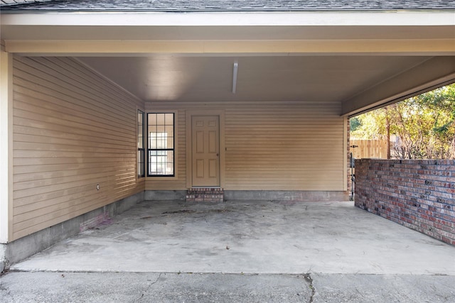 exterior space featuring fence and a carport