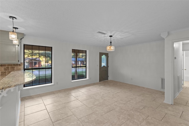 unfurnished dining area featuring visible vents and crown molding
