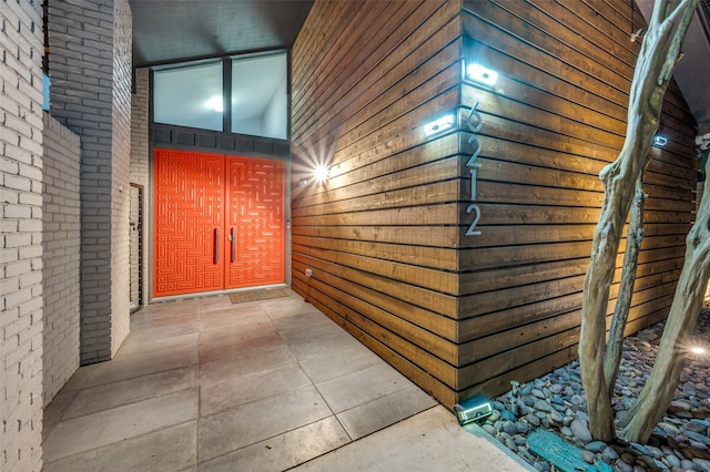 hallway with brick wall and high vaulted ceiling