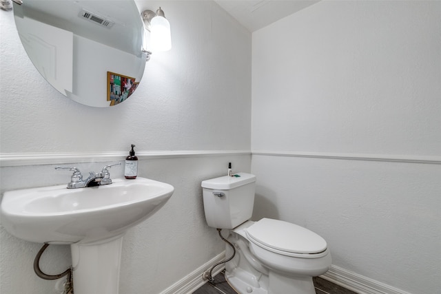 bathroom featuring toilet and sink