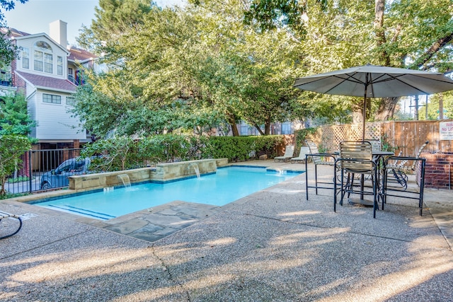 view of pool with a patio area and pool water feature