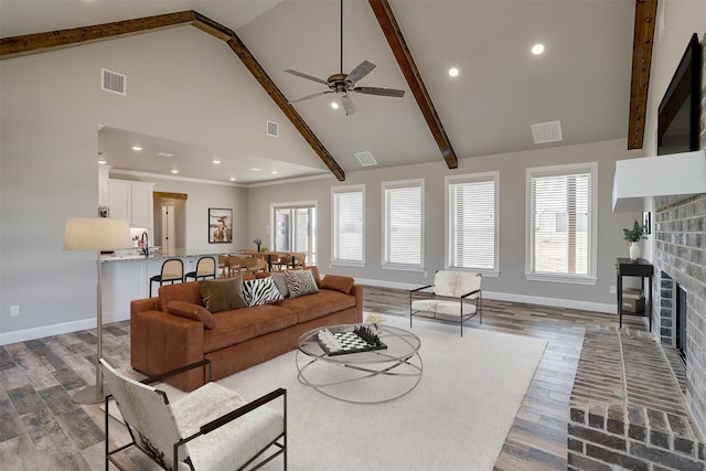 living room with beamed ceiling, a brick fireplace, dark hardwood / wood-style floors, and high vaulted ceiling