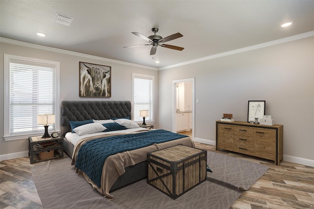 bedroom with ensuite bath, hardwood / wood-style flooring, ornamental molding, and ceiling fan