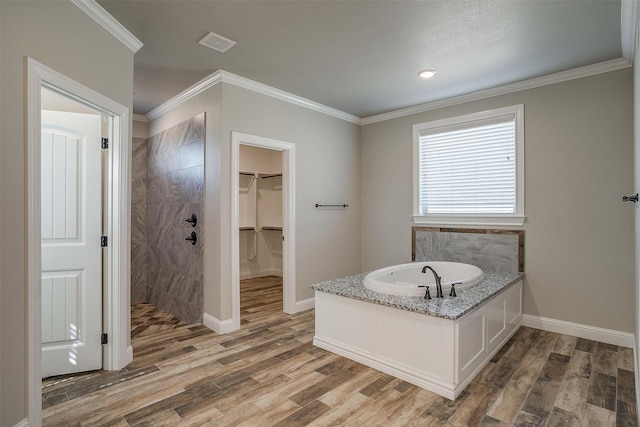 bathroom with independent shower and bath, hardwood / wood-style floors, and ornamental molding