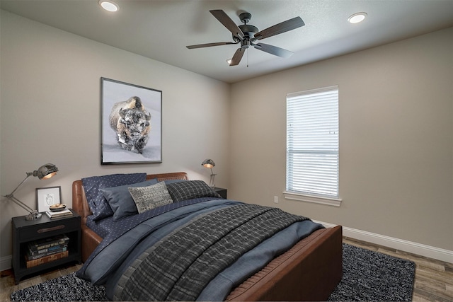 bedroom with hardwood / wood-style flooring and ceiling fan