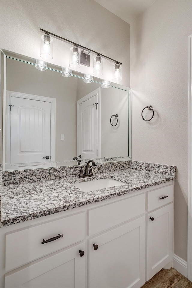 bathroom featuring vanity and hardwood / wood-style floors