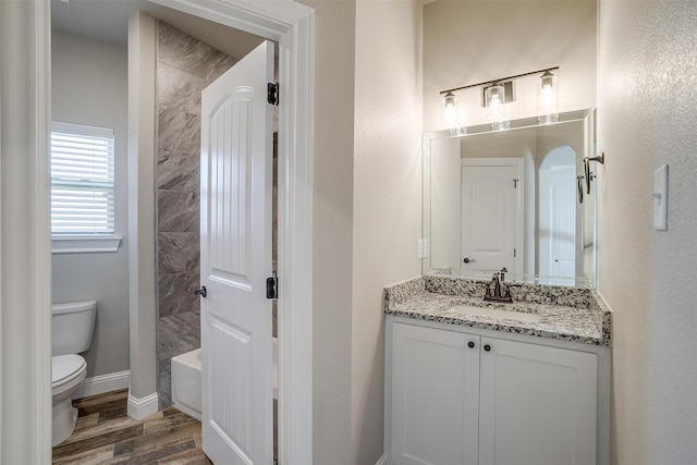 full bathroom featuring vanity, toilet, wood-type flooring, and plus walk in shower