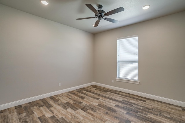 spare room with ceiling fan and wood-type flooring