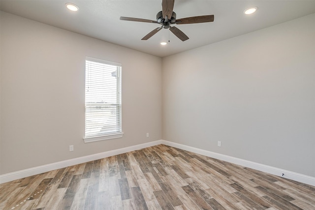 spare room featuring hardwood / wood-style floors and ceiling fan