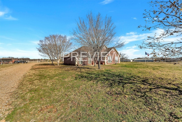 view of yard with a rural view