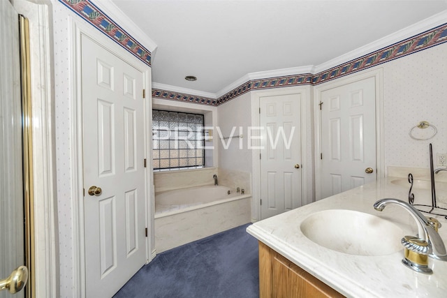 bathroom with a bathing tub, vanity, and ornamental molding