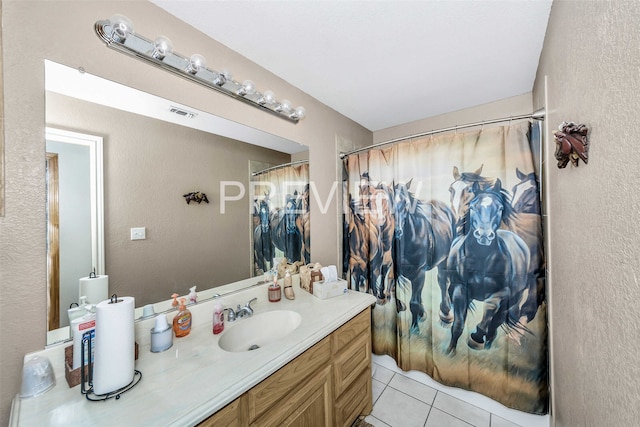 bathroom with a shower with curtain, vanity, and tile patterned floors