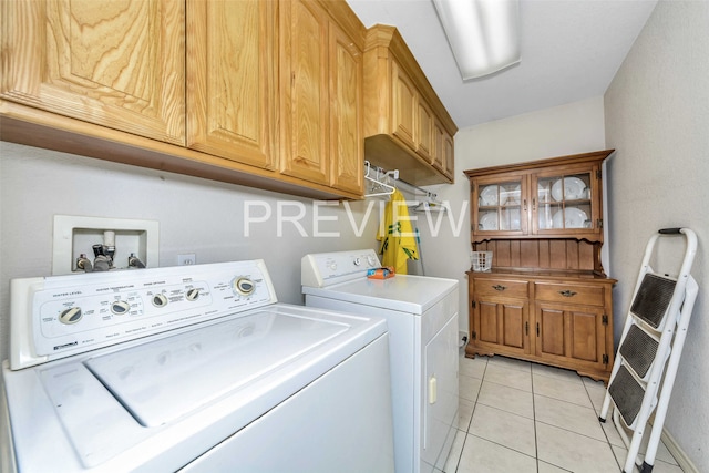 clothes washing area featuring cabinets, independent washer and dryer, heating unit, and light tile patterned floors