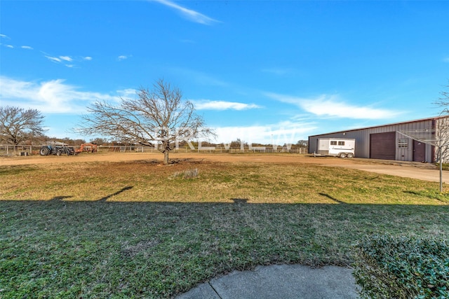 view of yard featuring a rural view and an outdoor structure