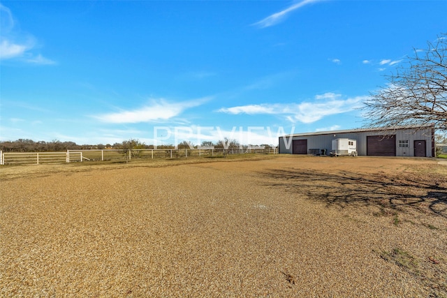 view of yard with a rural view and an outdoor structure