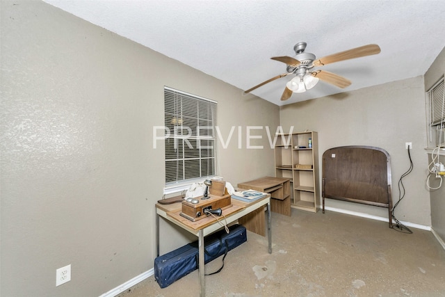 home office featuring ceiling fan, concrete floors, and a textured ceiling