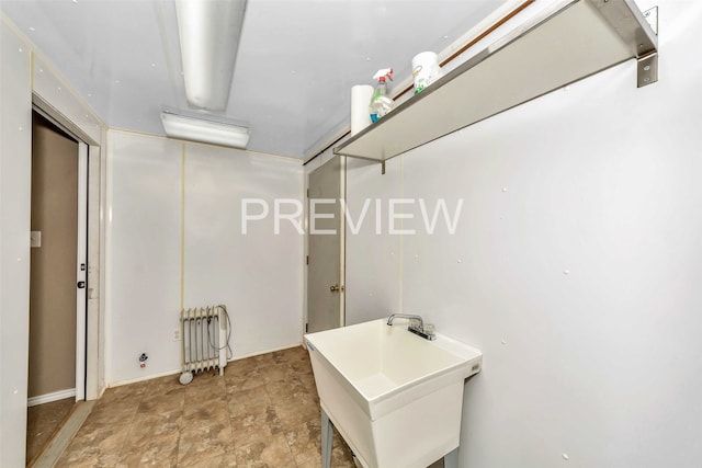 washroom featuring radiator heating unit and sink