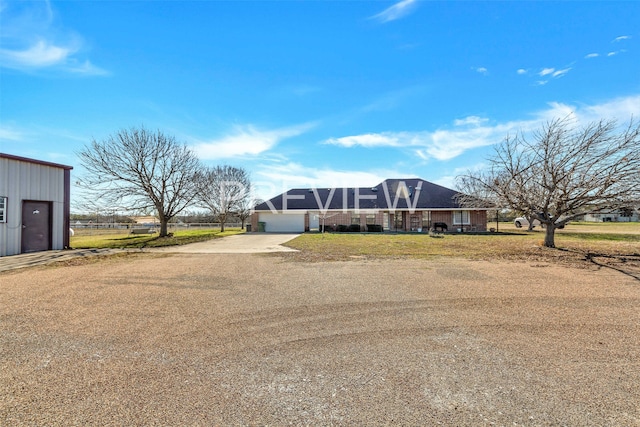 single story home with glass enclosure and a garage