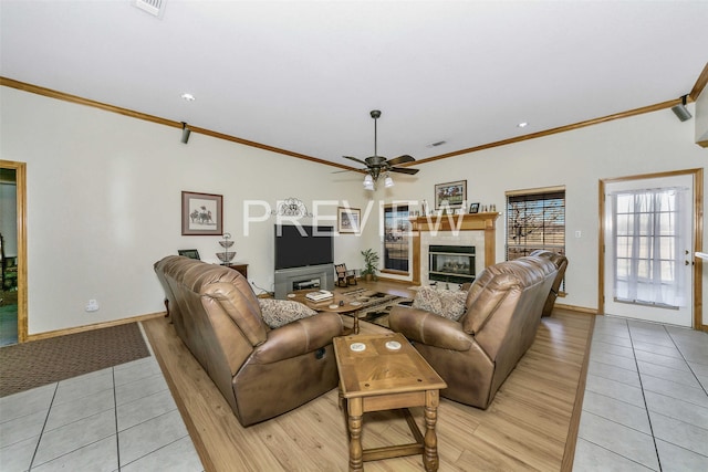 tiled living room featuring a fireplace, ceiling fan, and ornamental molding