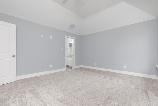 empty room with ceiling fan, carpet floors, and lofted ceiling