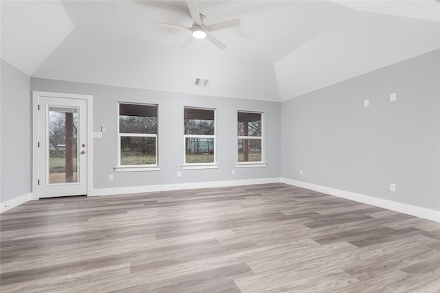 interior space featuring ceiling fan, a healthy amount of sunlight, vaulted ceiling, and light hardwood / wood-style flooring