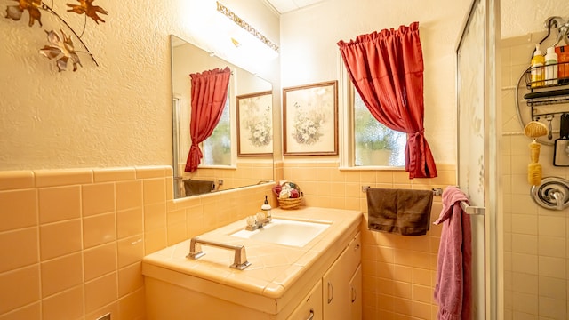 bathroom with tile walls and vanity