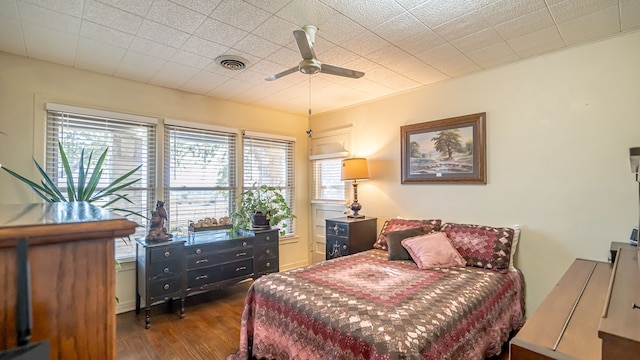 bedroom with dark hardwood / wood-style floors and ceiling fan