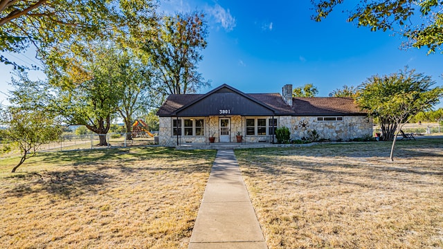 ranch-style house with covered porch and a front lawn