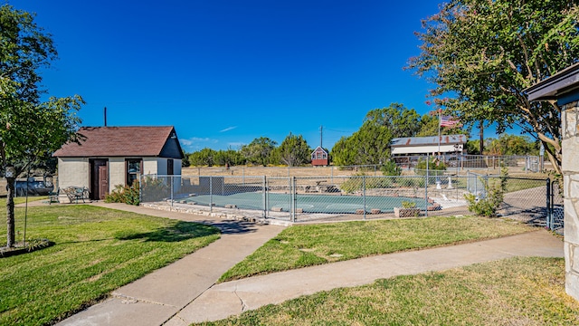 view of pool with a lawn