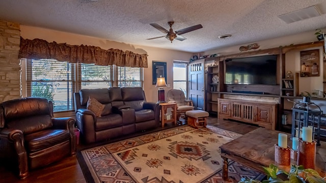 living room with dark wood-type flooring, a textured ceiling, and ceiling fan