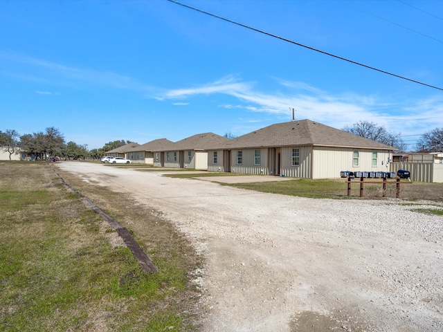 rear view of house featuring a yard