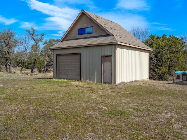 garage featuring a lawn