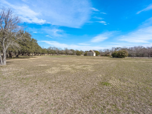 view of yard with a rural view and a storage unit