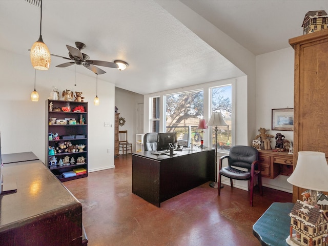 home office with a textured ceiling and ceiling fan