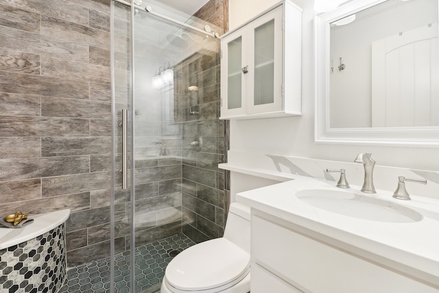 bathroom with vanity, toilet, and a shower with door