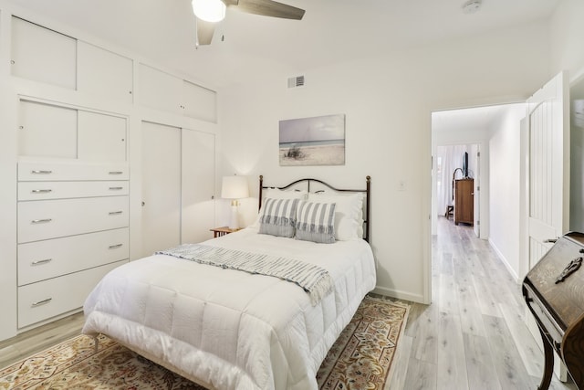 bedroom featuring light hardwood / wood-style flooring, a closet, and ceiling fan