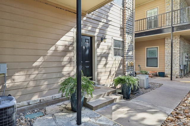 property entrance featuring a balcony and central AC