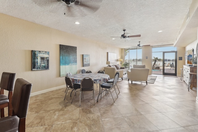 dining area with a textured ceiling and ceiling fan