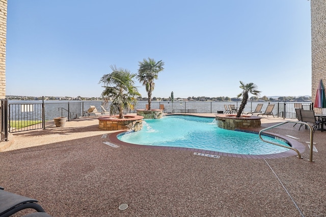 view of swimming pool with a jacuzzi, a patio area, and pool water feature