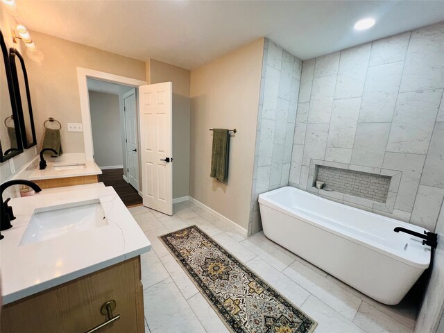 bathroom with vanity and a tub