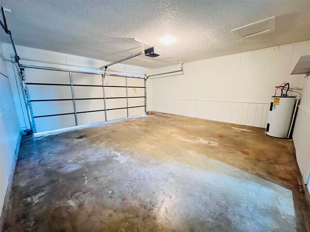 garage featuring a garage door opener and water heater