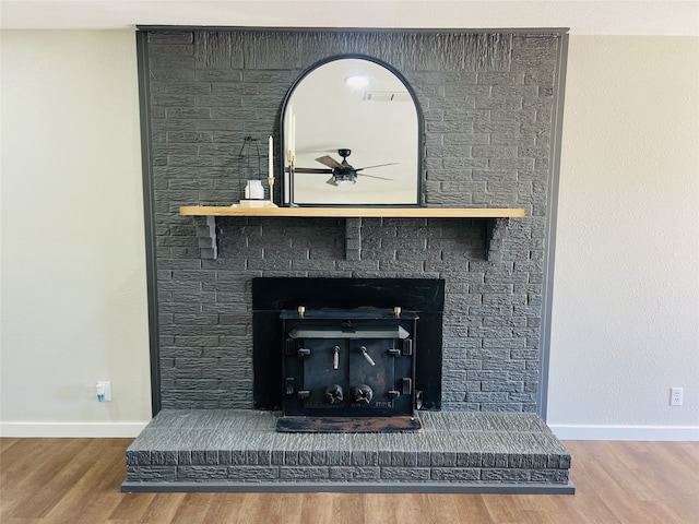 details featuring hardwood / wood-style floors, a fireplace, and ceiling fan