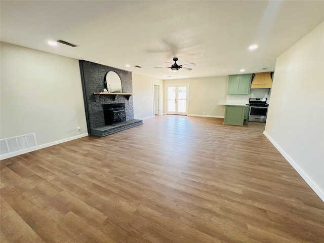 unfurnished living room with light hardwood / wood-style floors and ceiling fan