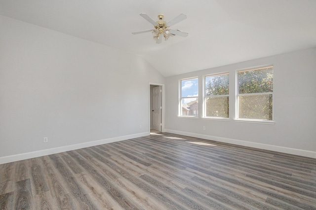 unfurnished room featuring ceiling fan, dark hardwood / wood-style flooring, and vaulted ceiling