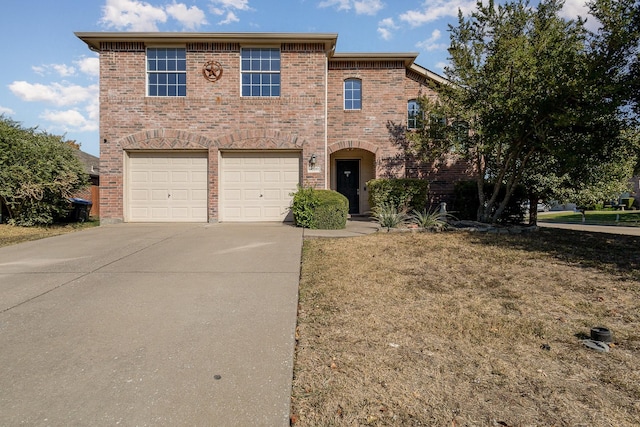 view of front property featuring a garage and a front yard