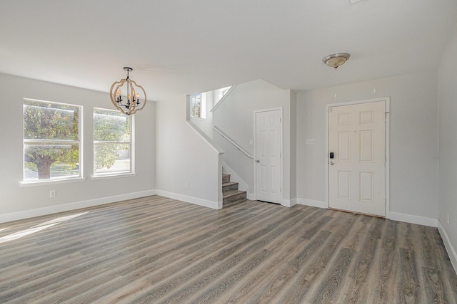 foyer entrance featuring dark hardwood / wood-style floors and an inviting chandelier